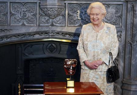 Britain's Queen Elizabeth poses with her honorary BAFTA award in recognition of a lifetime's support of British film and television, at Windsor Castle in southern England
