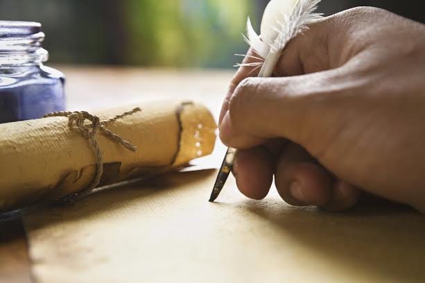 Hand writing on old parchment / paper using quill pen